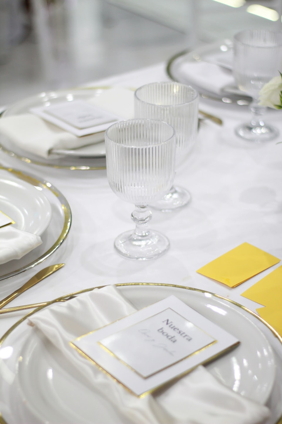 Elegant table setting with gold accents for a wedding celebration.